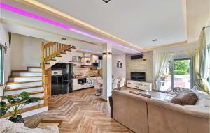 a living room with a couch and a staircase at Three-Bedroom Holiday Home In Grab in Grab