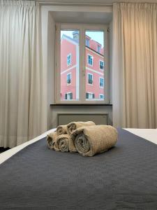 a bedroom with a bed with a large window at Martel Rooms - Genova Centro Brignole in Genova
