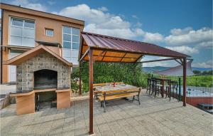 a pavilion with a table and a stone oven at Awesome Home In Seget Donji in Seget Donji +39 photos