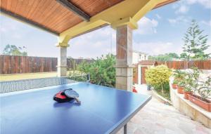 a blue ping pong table with a hat on it at Amazing Home In Torre Di Pescopaganoce in Castel Volturno