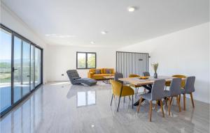 a dining room and living room with a table and chairs at Stunning Home In Obrovac Sinjski in Obrovac Sinjski