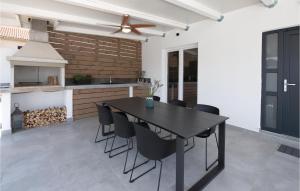 a dining room with a black table and black chairs at Gorgeous Home In Betina in Betina
