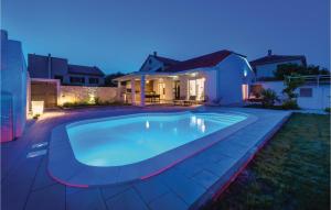 a swimming pool in the backyard of a house at night at Gorgeous Home In Betina in Betina +31 photos