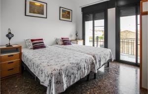 a bedroom with a large bed and a window at Amazing Home In Deltebre With Kitchen in Deltebre