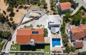 an aerial view of a house with a swimming pool at Amazing Apartment In Novalja With Wifi in Novalja