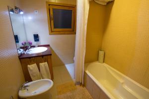 a bathroom with a sink and a toilet and a tub at Quinta dos Curubas in Vila Franca do Campo +34 photos