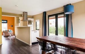 a kitchen and dining room with a wooden table and chairs at Nice Home In Vlagtwedde With Wifi in Vlagtwedde