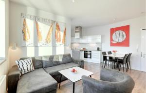 a living room with a couch and chairs and a table at Passatvilla - Apartment 2 in Travemünde