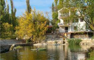 a person in a kayak on a river next to a house at Holiday Home Grab I in Grab +45 photos