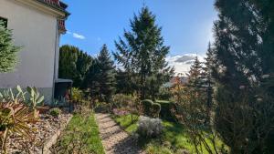 a garden next to a house with trees at Pension Central in Ústí nad Labem