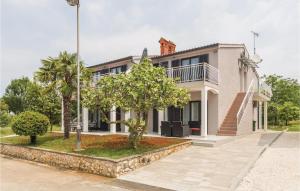 ein großes weißes Haus mit Bäumen davor in der Unterkunft Apartment Korculanska Croatia in Poreč