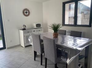 a kitchen with a dining room table and chairs at Maison du Champblanc 2 chambres in Bourbon-Lancy