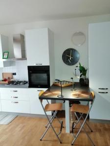 a kitchen with a table and chairs in a kitchen at Appartamento Angela in Cento