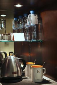a coffee cup sitting on top of a kitchen counter at Centro Al Manhal by Rotana in Abu Dhabi