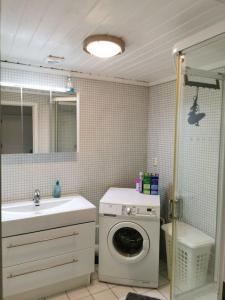 a bathroom with a washing machine and a sink at Solrikt med kort avstand til byen in Sandefjord +25 photos
