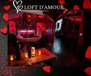 a red room with a bed and a table with candles at Loft d'amour in Ligné