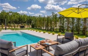 a patio with a table and chairs next to a pool at Villa Lu in Šibenik