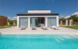 a house with chairs and a swimming pool at Villa Lu in Šibenik +48 photos