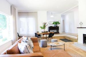 a living room with a couch and a table at Luxury Poolside Villa Irene in Cape Town