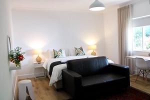 a bedroom with a bed and a black leather chair at Luxury Poolside Villa Irene in Cape Town +66 photos