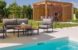 a patio with a table and chairs next to a pool at Villa Lu in Šibenik