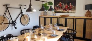 a dining room with a table and a bike on the wall at Quiet nice place Meine in Meine