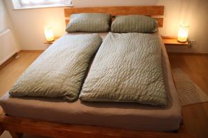 a bed with two pillows on it in a bedroom at FeWo Hotzelche in Boppard
