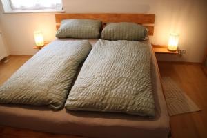 a bed with two pillows on it in a bedroom at FeWo Hotzelche in Boppard
