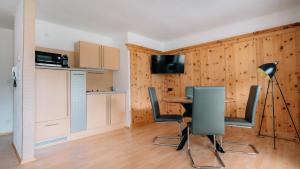 a kitchen and dining room with a table and chairs at Apart Gipfelglück in Längenfeld