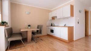 a small kitchen with a table and chairs in a room at Apart Gipfelglück in Längenfeld +2 photos