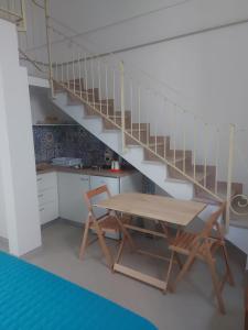a kitchen with a table and a staircase at Casa Vacanza Santa Lucia in Meta +14 photos