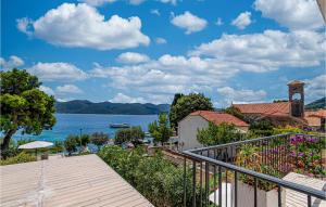 a balcony with a view of the water and a building at Stunning Home In Viganj in Viganj +42 photos