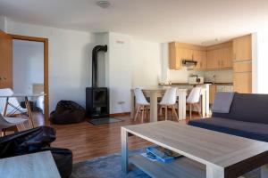 a living room with a couch and a wood stove at Espacioso y luminoso duplex con buhardilla in Valdelinares