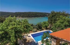 an image of a swimming pool next to a lake at Amazing Home In Kampor in Supetarska Draga +50 photos