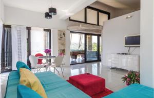 a living room with a blue couch and a table at Amazing Home In Kampor in Supetarska Draga