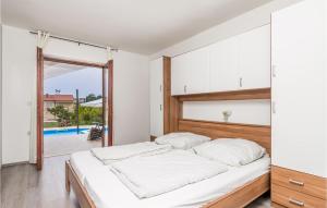 une chambre avec un lit et une porte coulissante en verre dans l'établissement Nice Home In Banjol With Wifi, à Banjol