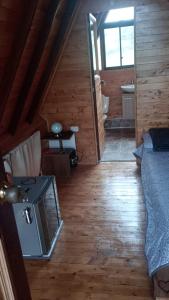 a attic room with a bed and a bathroom at Lago Cristal Chalets in Bucaramanga