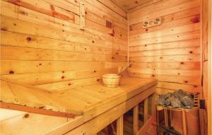a log cabin with a wooden wall at Cozy Home In Cujica Krcevina in Čujića Krčevina