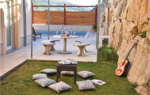 - un jardin avec une table, des chaises et une guitare dans l'établissement Cozy Home In Podstrana With Sauna, à Podstrana 47 autres photos