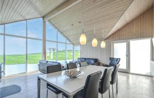 a dining room with a table and chairs at Holiday Home Knebel 26 in Knebel