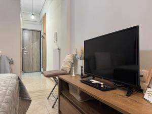 a living room with a large flat screen television on a table at Evann's sweet home in Larisa
