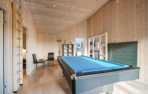 a pool table in a room with wooden walls at Holiday Home Knebel 26 in Knebel