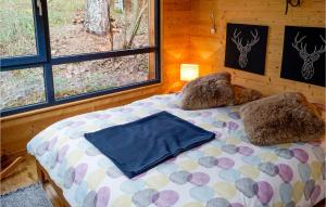 a bedroom with a bed in a cabin with windows at Lovely Home In Labaroche With Sauna in Labaroche