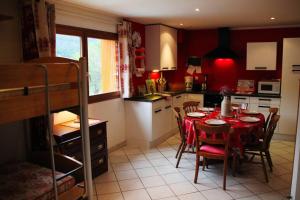 a kitchen with a table and chairs in a room at Appartement T2 - Centre Lélex in Lélex