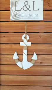a metal anchor hanging on a wood wall at Mobile Home L&L in Drage