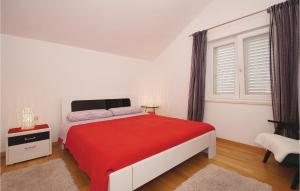 une chambre blanche avec un lit rouge et une fenêtre dans l'établissement Three-Bedroom Apartment In Racisce, à Račišće