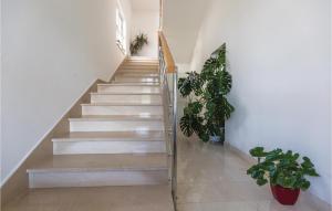 a stairway with potted plants in a hallway at Apartment Vukovarska Iv in Makarska