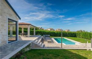 a backyard with a swimming pool and a gazebo at Villa Edoardo in Vižinada