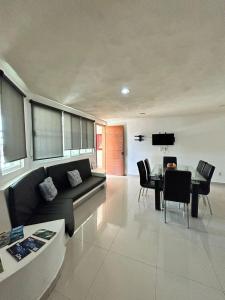 a living room with a couch and a table at Apartamento inn cancun in Cancún