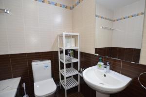 a bathroom with a white toilet and a sink at Awesome Sea & Marina View City Center 1 Bdr Flat in Larnaka +13 photos
